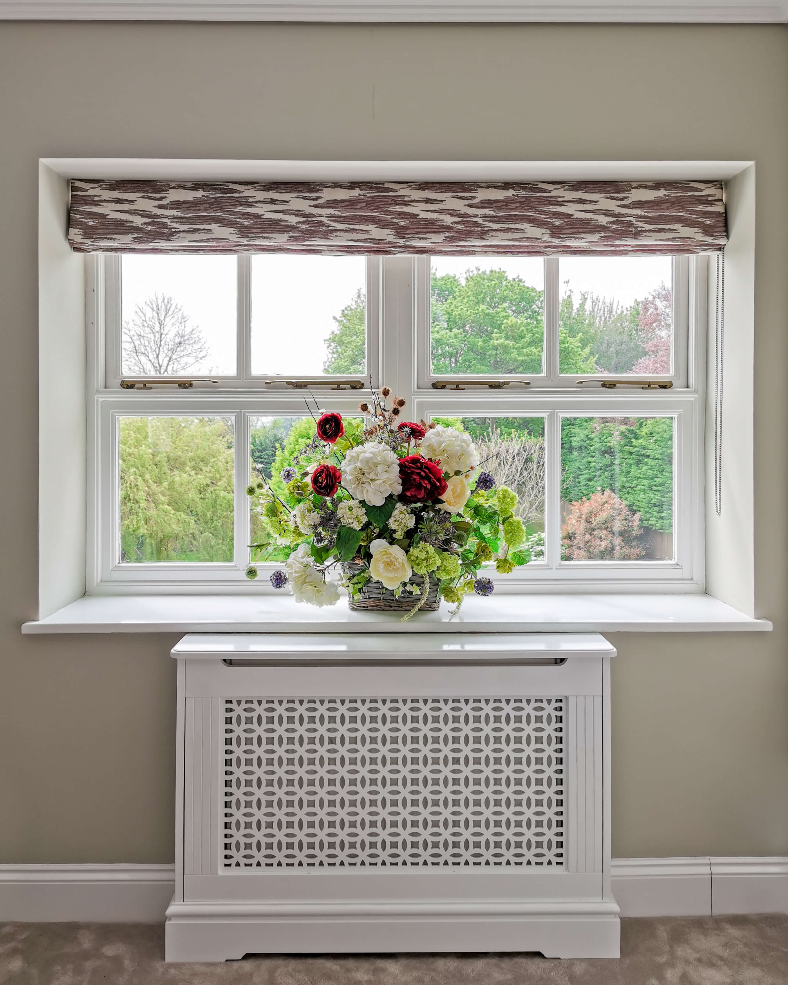 Patterned roman blind and flowers