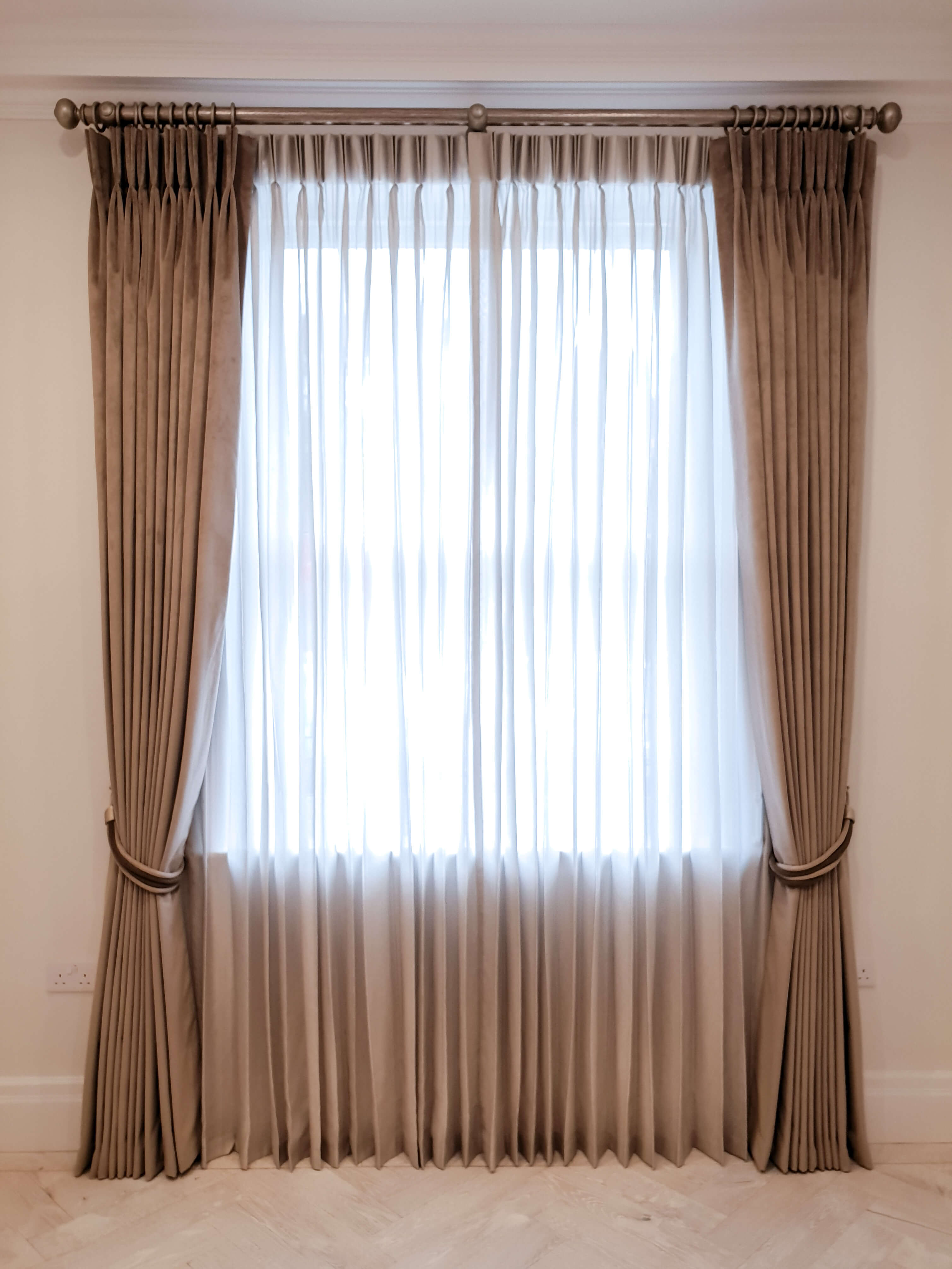 Curtains on a wooden pole with sheers