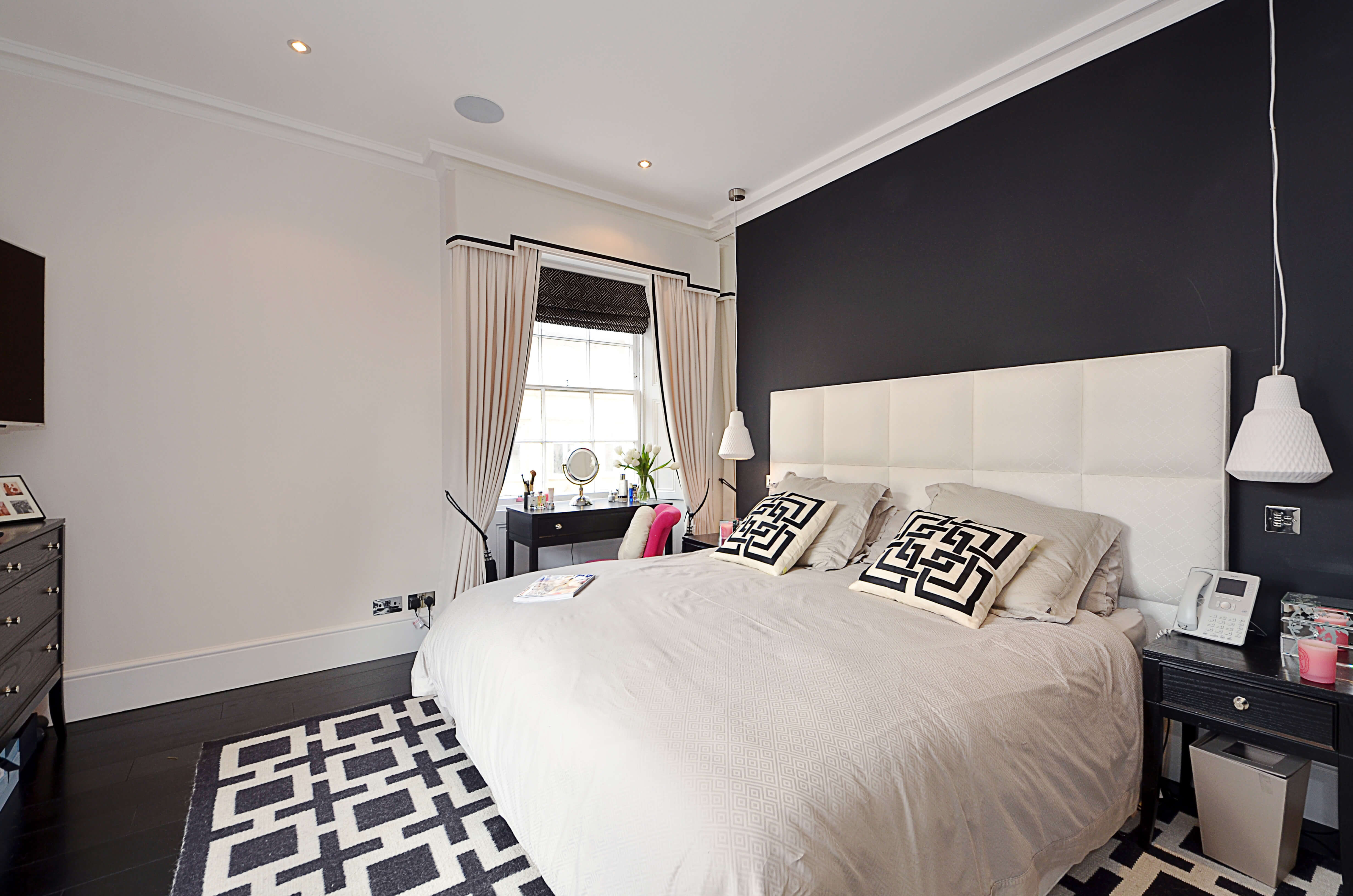White bordered curtains with shaped pelmet and tiebacks