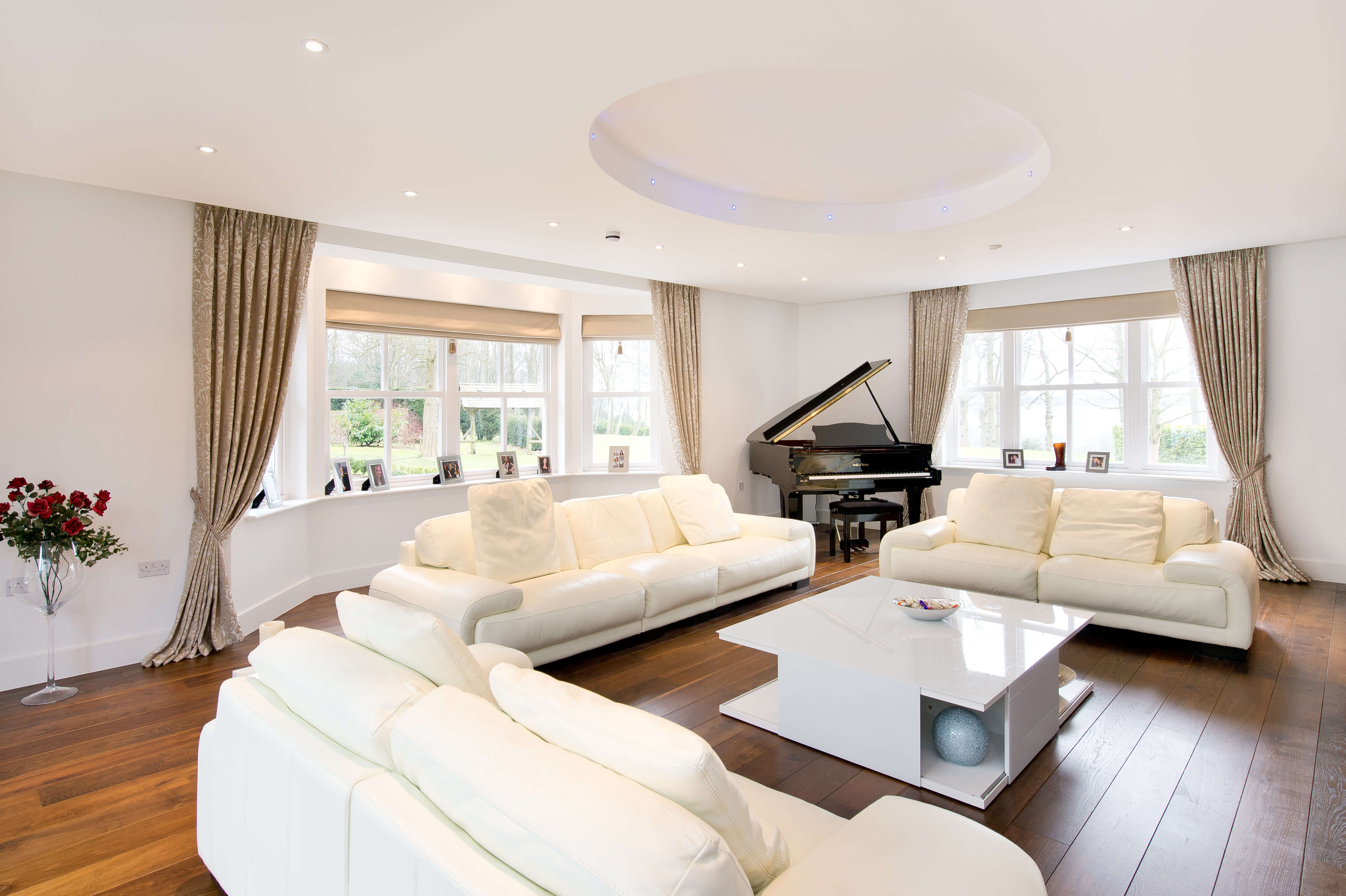 Living room with gold curtains and roman blinds