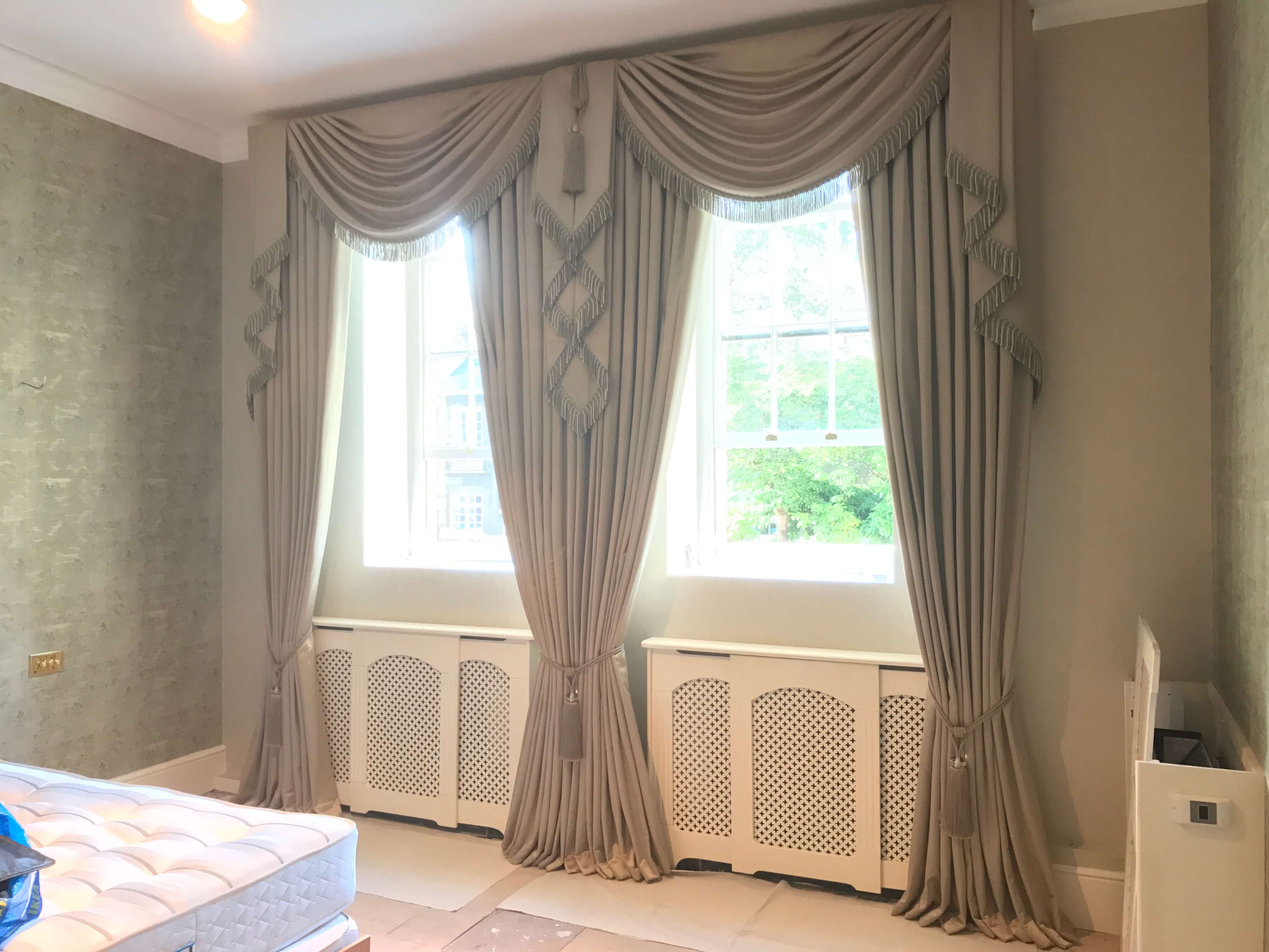 Bespoke drapes with swags and tiebacks in gold