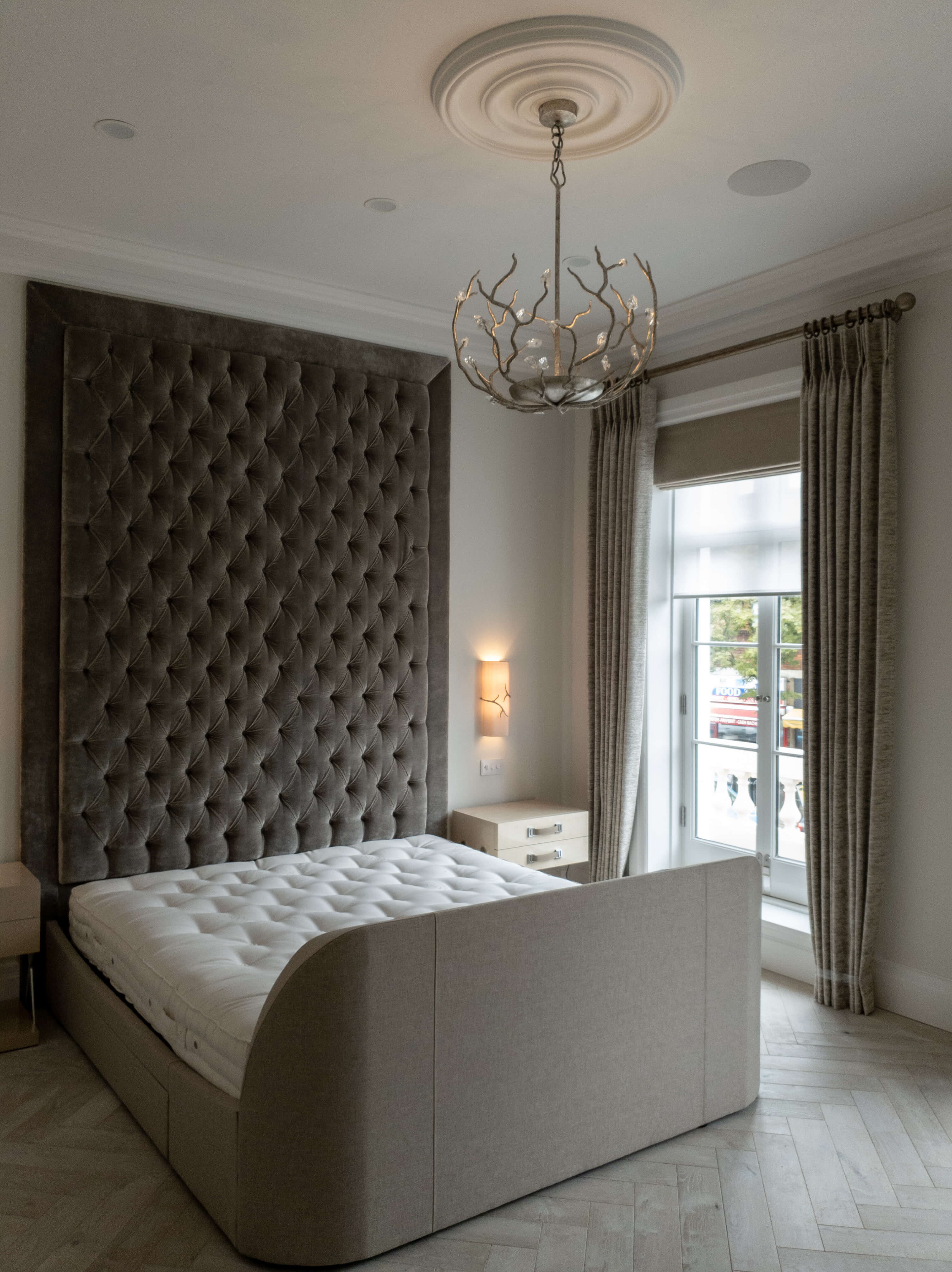 Grey curtains on a pole with roman blind and sheer roller blind
