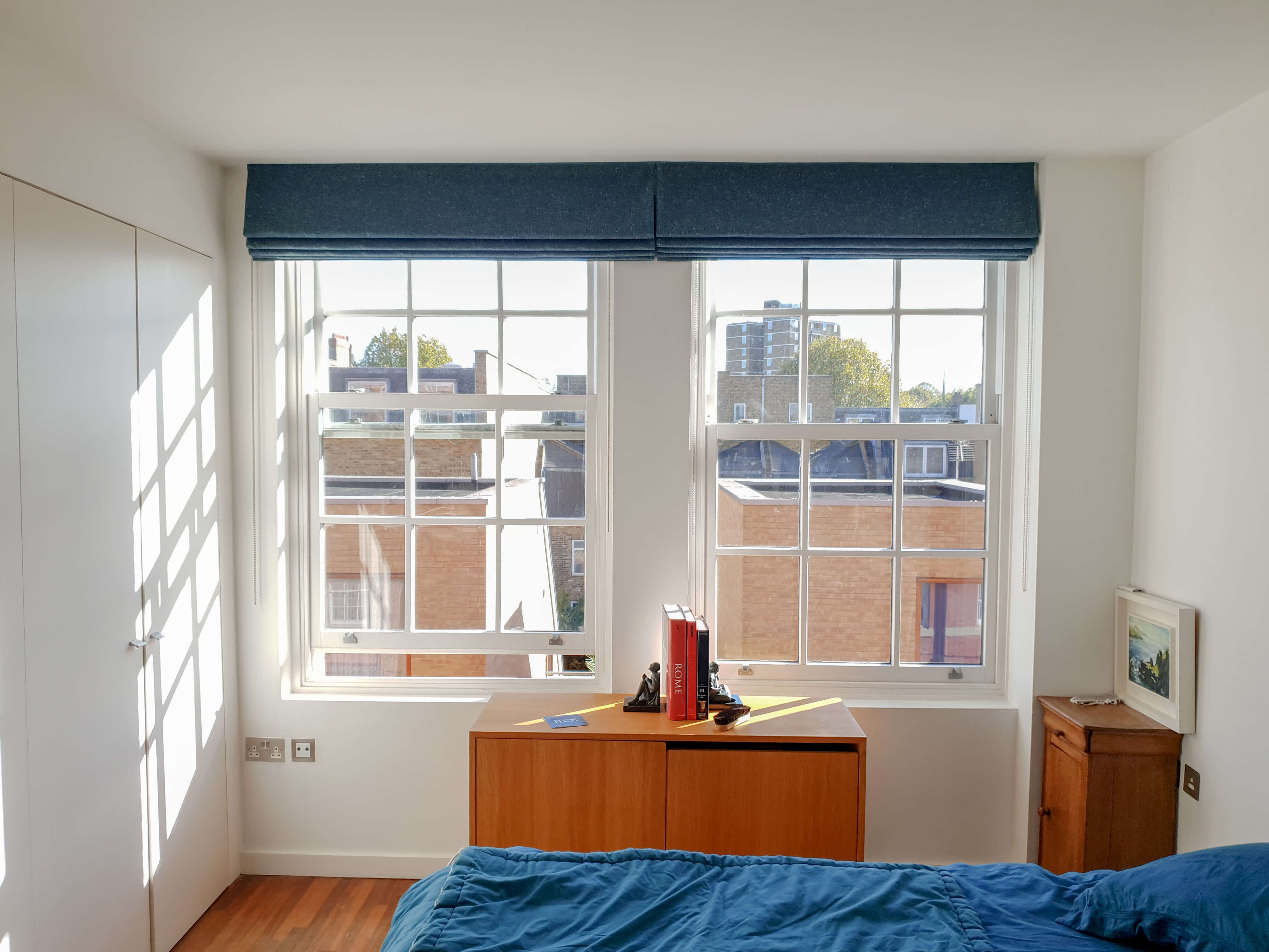 Two blue bespoke roman blinds