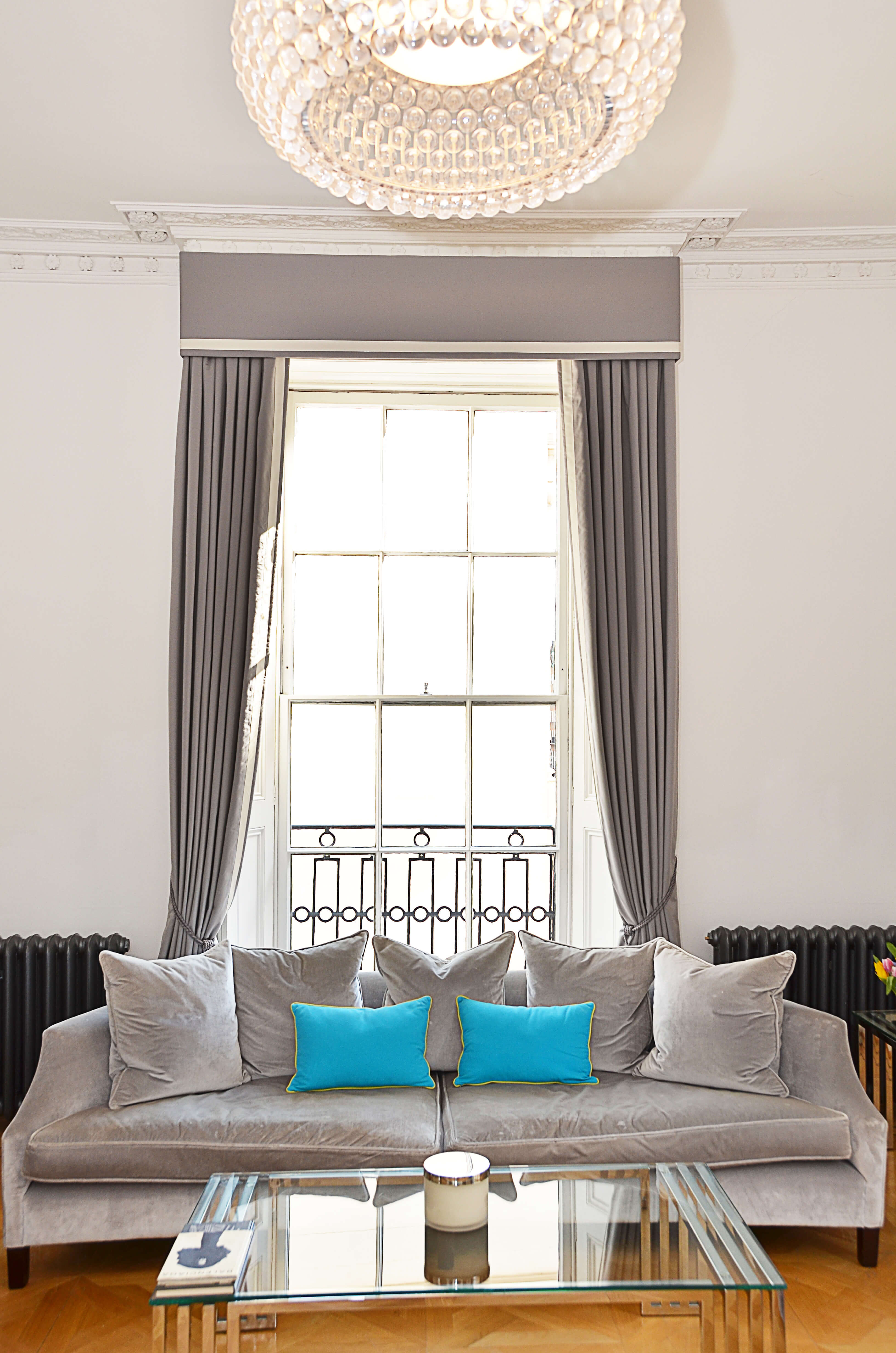 Grey bordered curtains with box pelmet and tiebacks