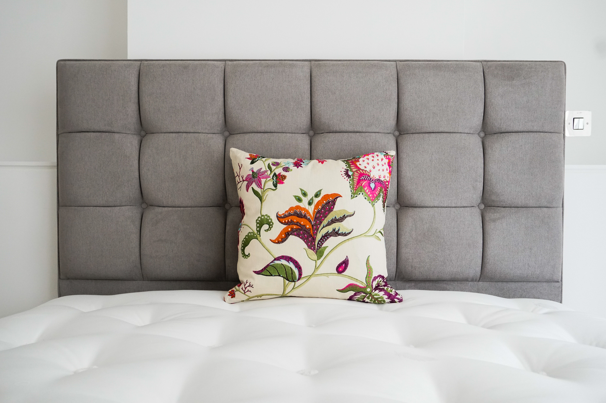 Bespoke upholstered cushion against headboard